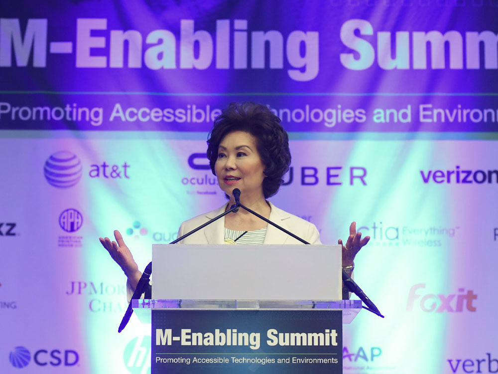 Elaine Chao speaking at the M-Enabling Summit